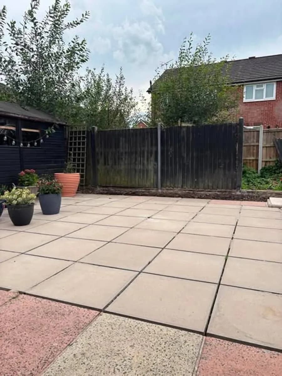 A finished fence run beside a patio