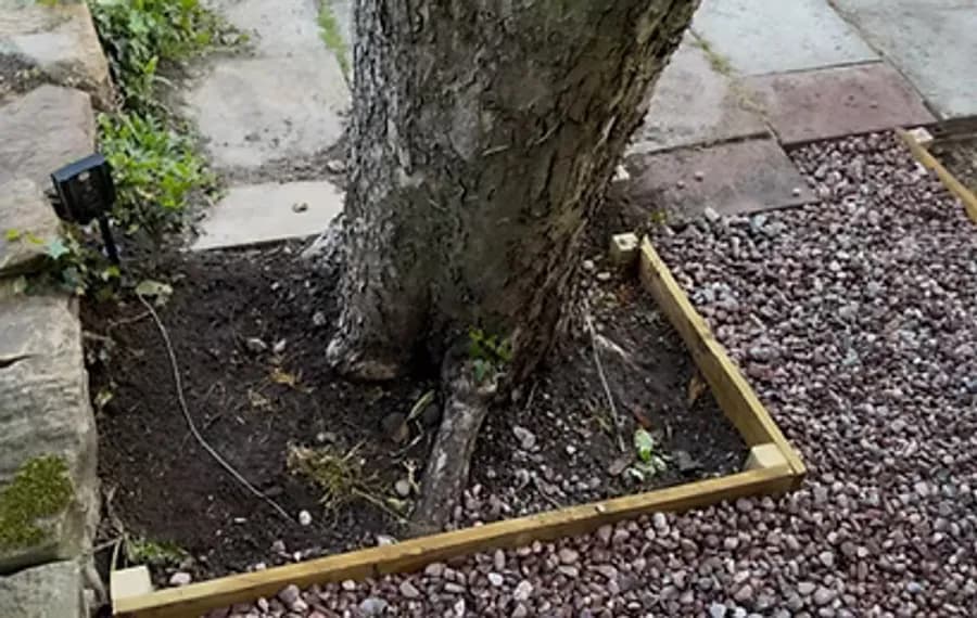 A finished sleeper border around a tree