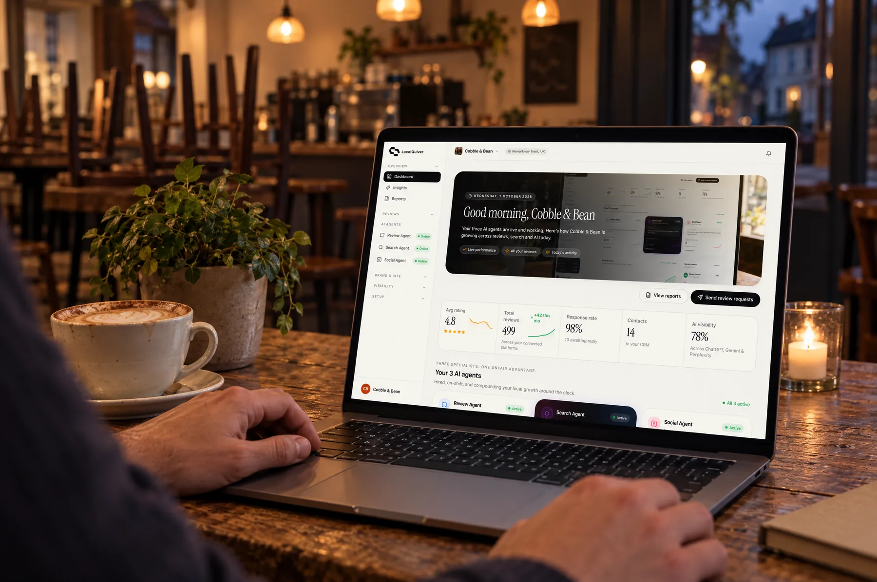 The Cobble & Bean dashboard open on a laptop after closing time, chairs stacked behind